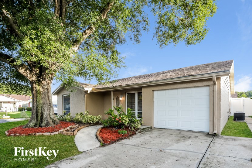 A house with a tree in front of it.