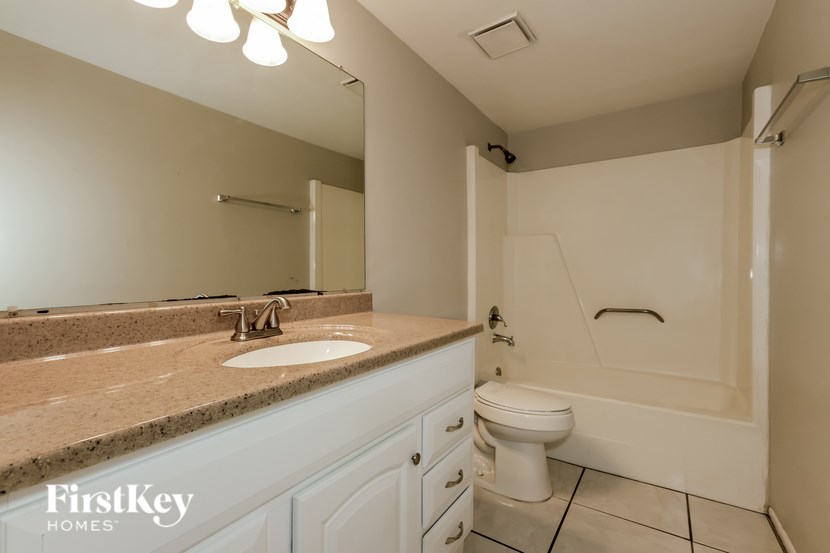 A bathroom with a sink, toilet, and bathtub.
