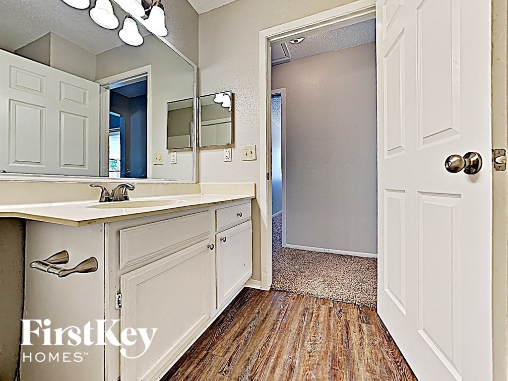 an open bathroom with a sink and a mirror
