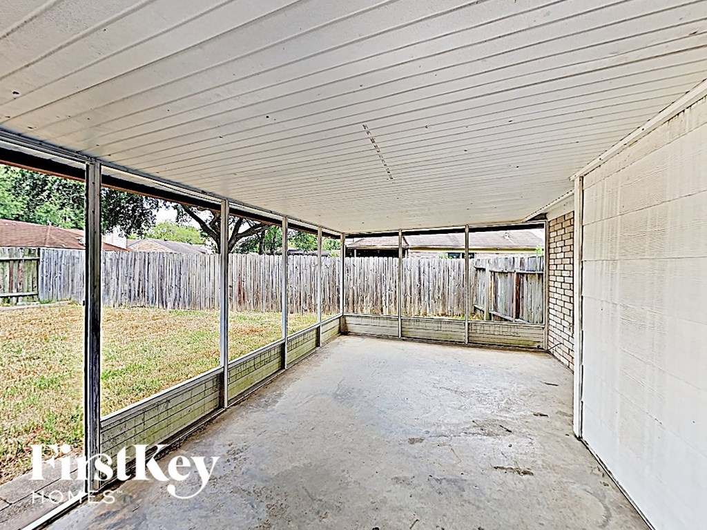 the inside of an empty chicken coop with a concrete floor and a fence