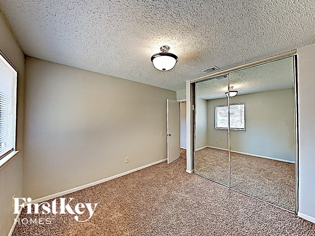 a bedroom with a mirror and a closet