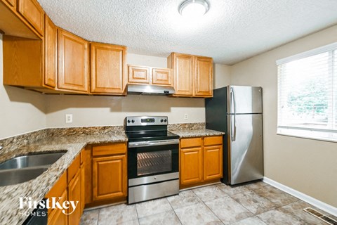 a kitchen with wooden cabinets and stainless steel appliances