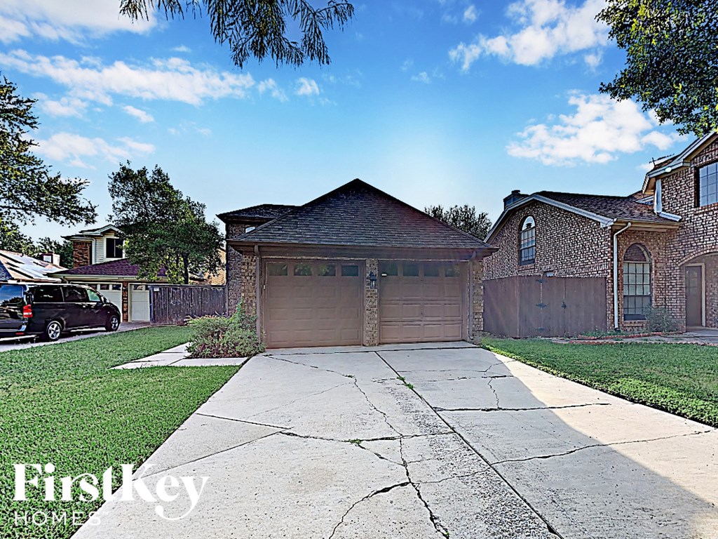a house with a driveway and a garage door