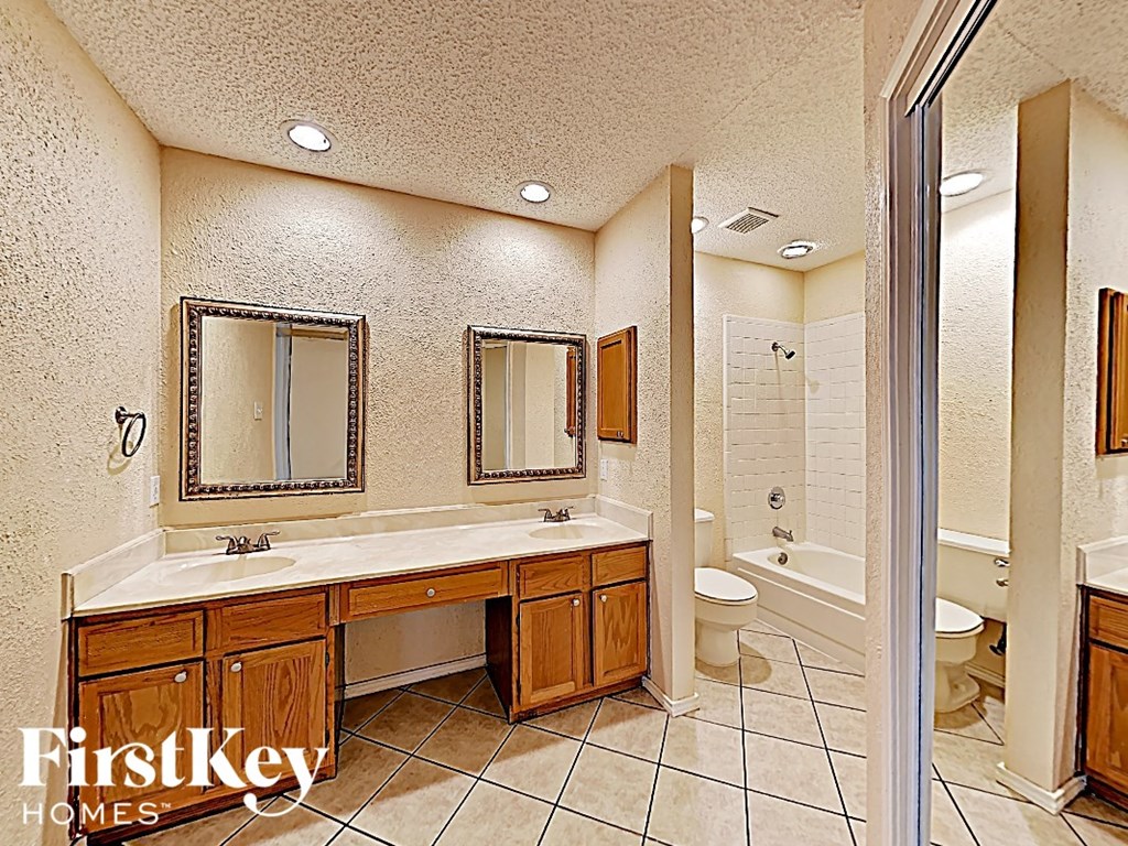 a bathroom with a sink and a toilet and a shower