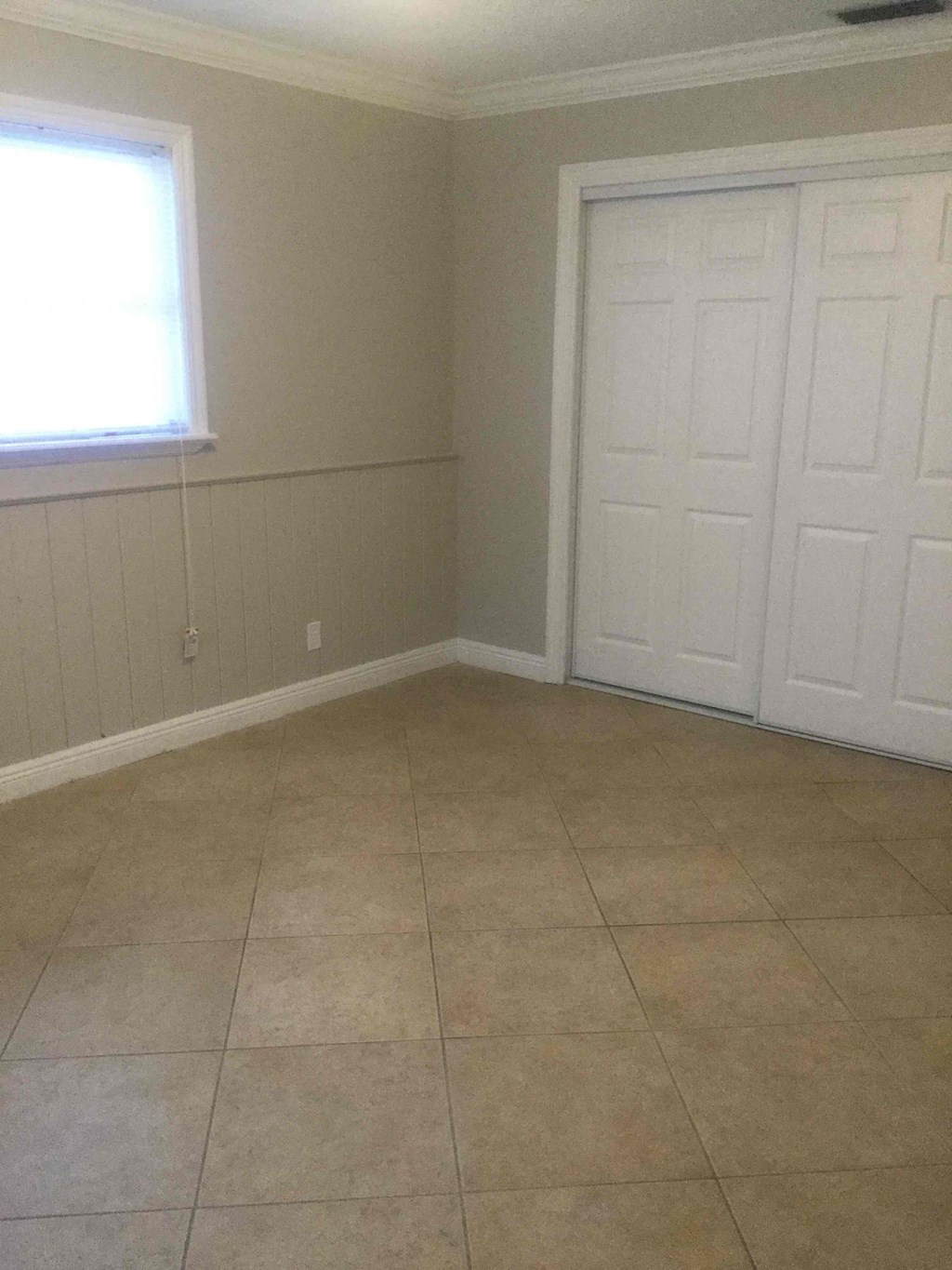 A room with a white door and a window.