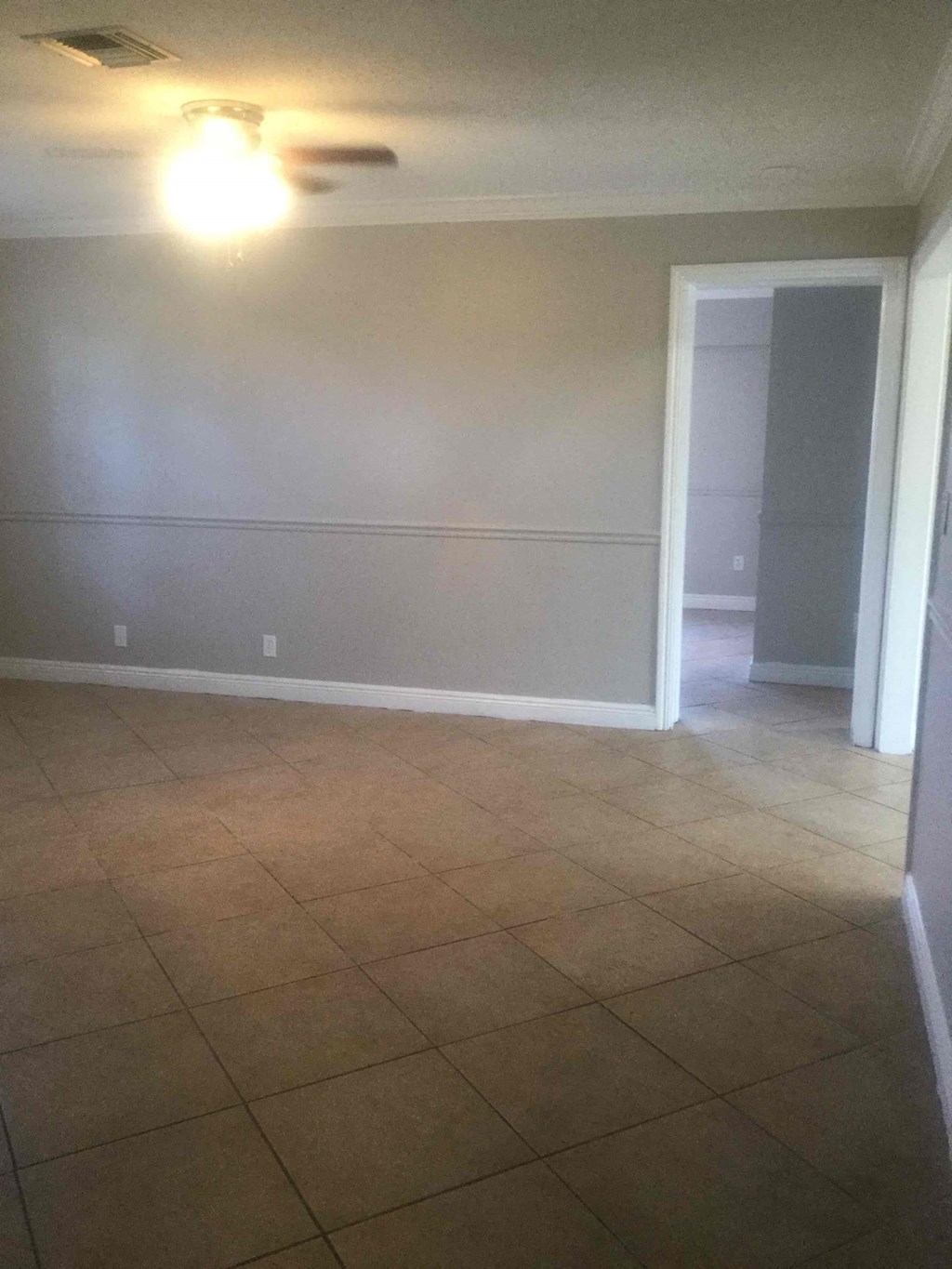 A room with a light on and a door.