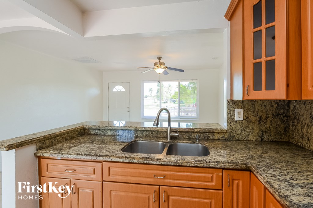 A kitchen with a sink and a fan.