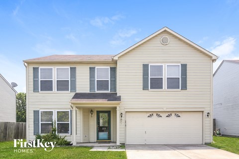 a beige house with a white garage door