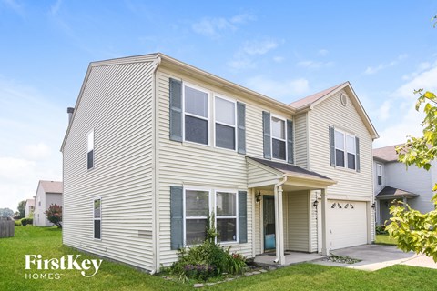 a white house with white siding and a white garage