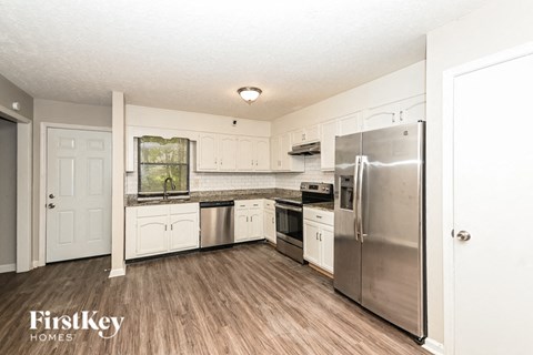 a kitchen with stainless steel appliances and white cabinets