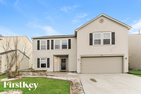 A two-story house with a garage is for sale.