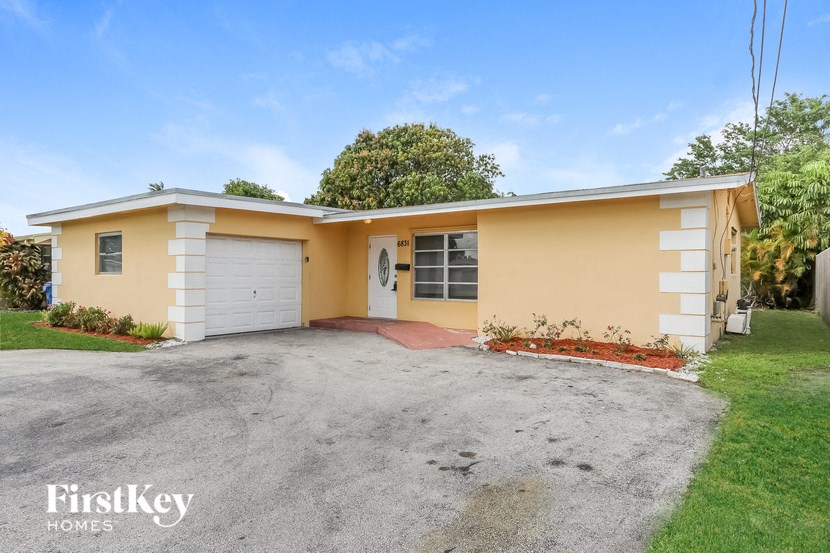 A two-story house with a garage is for sale.