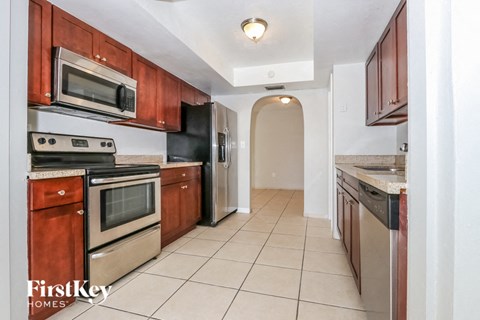 A kitchen with wooden cabinets and stainless steel appliances.