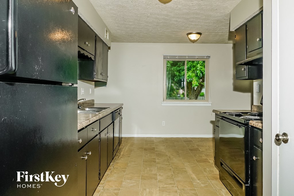 a kitchen with stainless steel appliances and black cabinets