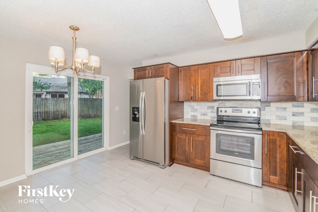 a kitchen with wooden cabinets and stainless steel appliances