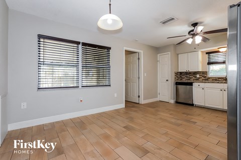 the living room and kitchen are open to the kitchen and dining room