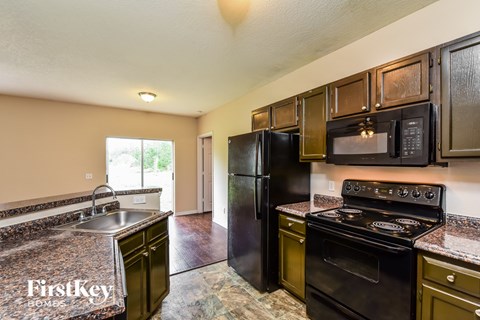 a kitchen with black appliances and granite counter tops