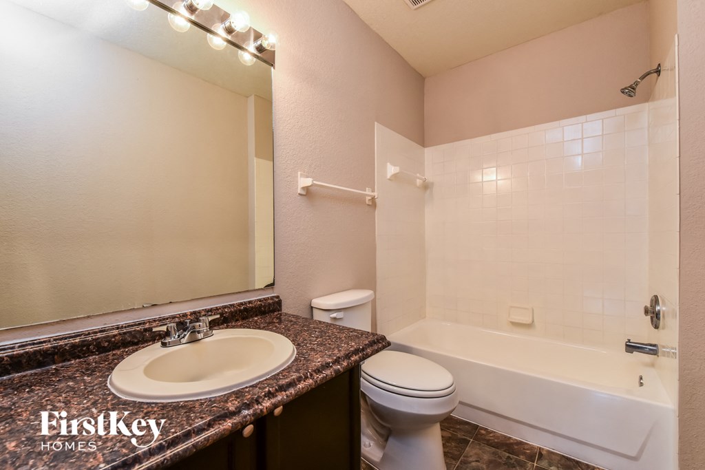 a bathroom with a sink toilet and a bath tub