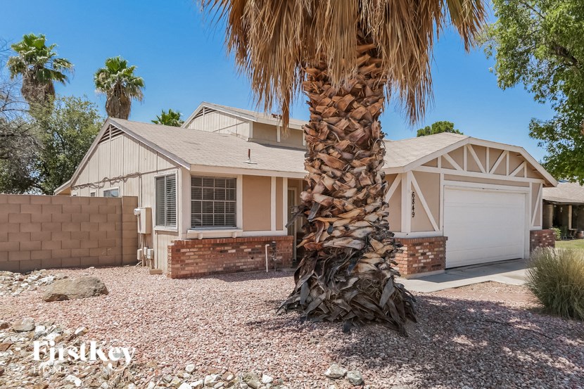 a palm tree in front of a house