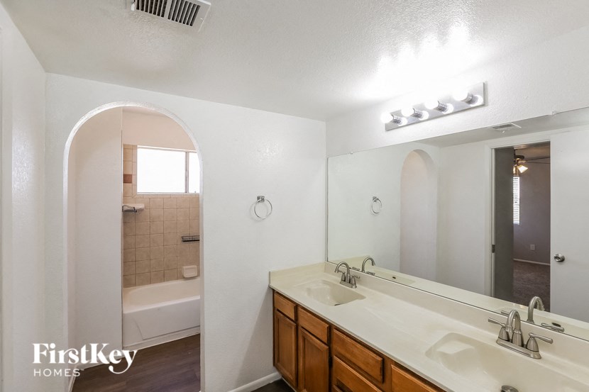 a bathroom with two sinks and a large mirror