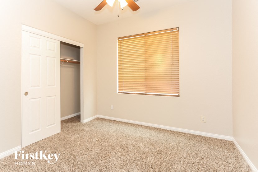 a room with carpet and a window and a closet