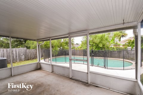 A pool in a backyard with a FirstKey Homes logo.