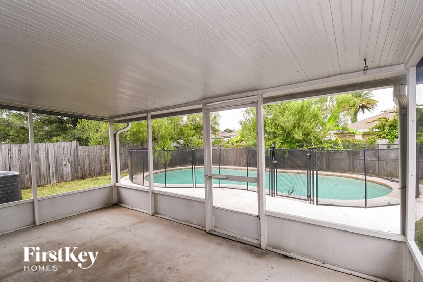 A pool in a backyard with a FirstKey Homes logo.