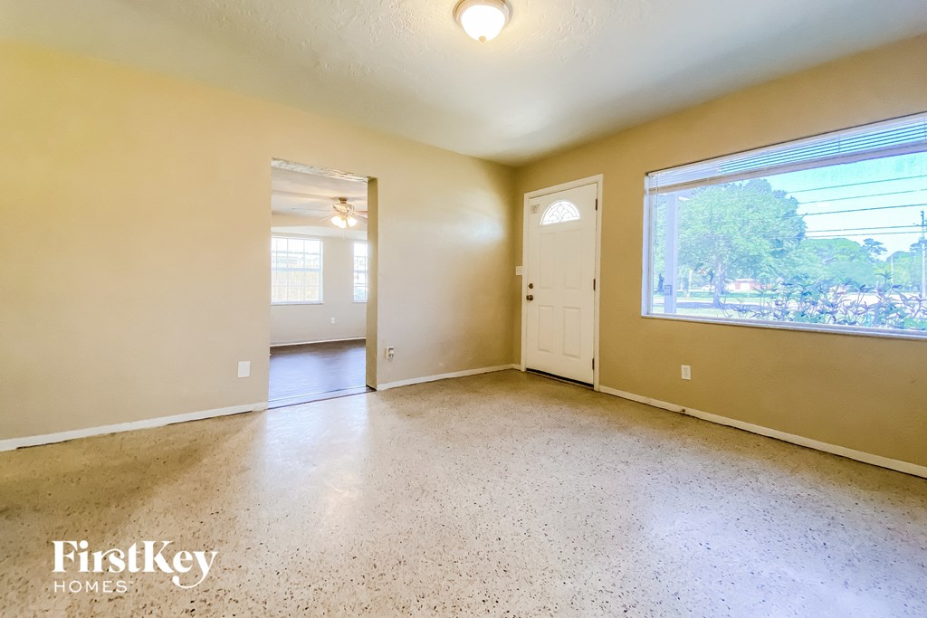 the living room of an empty house with a large window