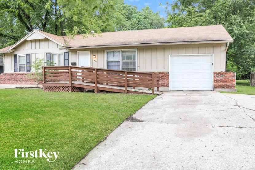 A house with a white garage door is for sale.