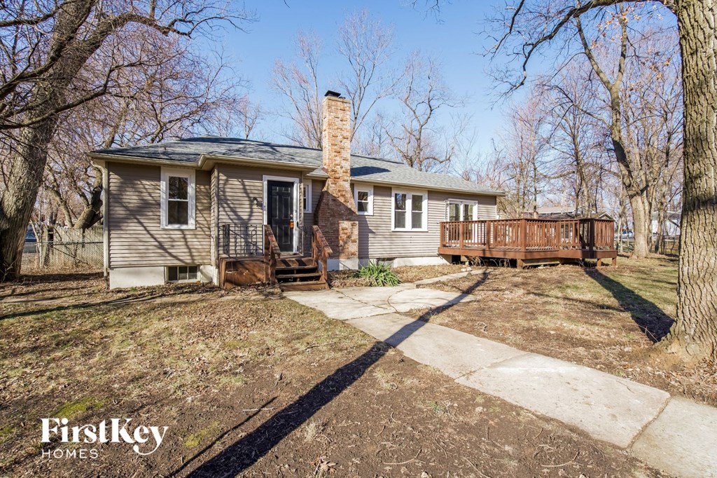 a small house with a deck and a wood deck