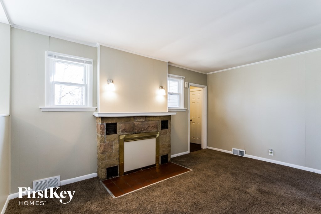 a living room with a fireplace and a door to a bathroom