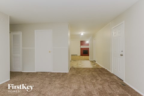 A room with a carpeted floor and white walls.