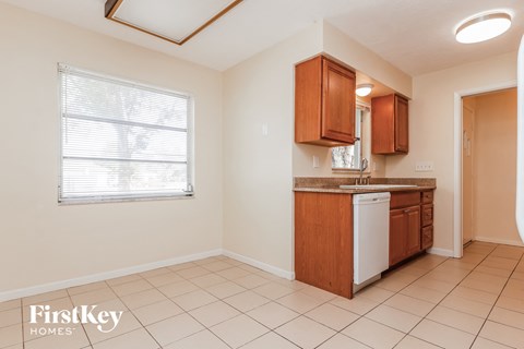a kitchen with a sink and a dishwasher and a window