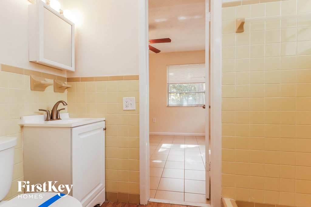 a bathroom with a shower and a sink and a toilet