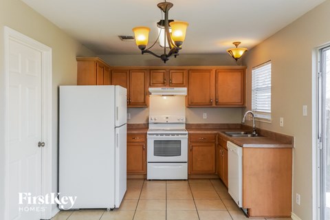 A kitchen with wooden cabinets and white appliances.