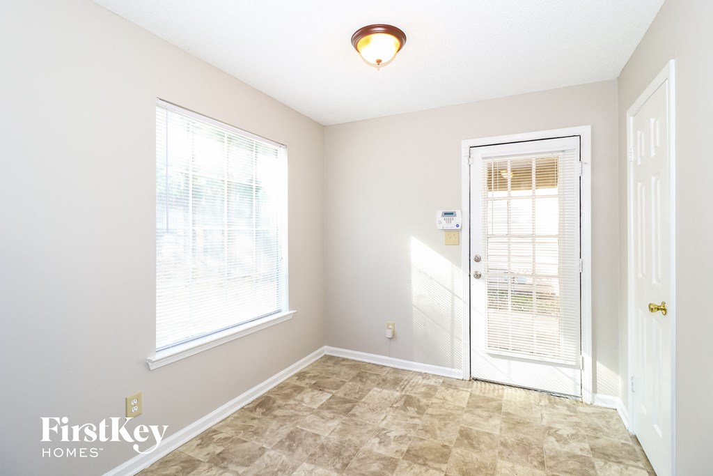 a living room with a door and a window