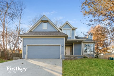 a blue house with a gray garage door