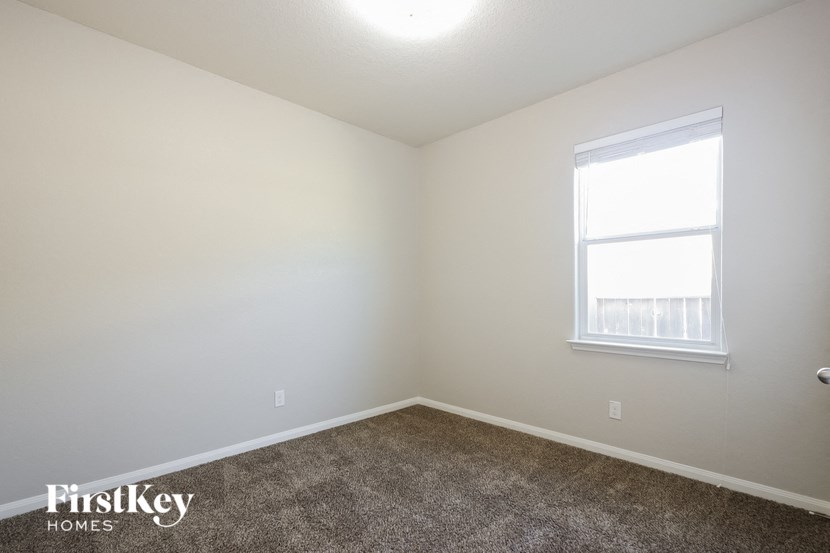 a room with a carpeted floor and a window