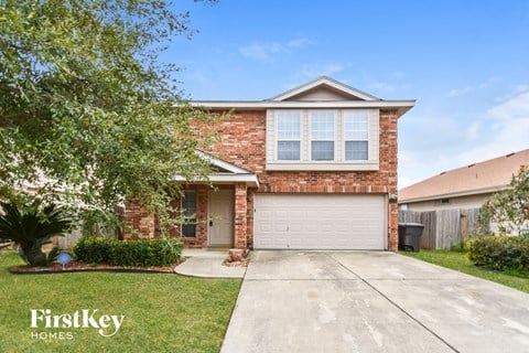 a small brick house with a white garage door