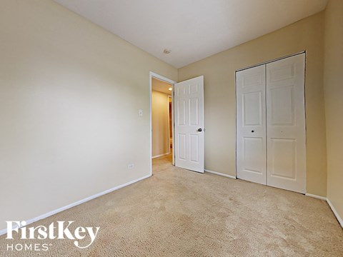 a bedroom with two closets and a door to a hallway