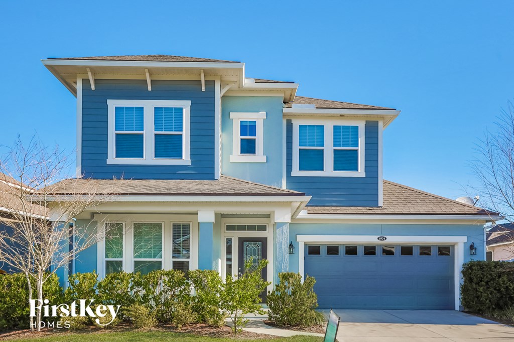 a blue house with a blue garage door