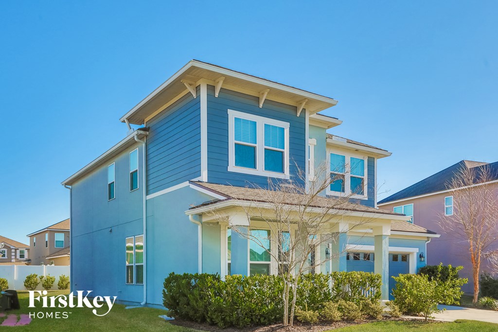 a blue house with a tree in front of it