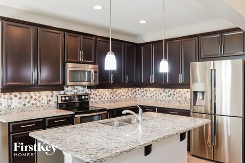 a kitchen with stainless steel appliances and granite counter tops