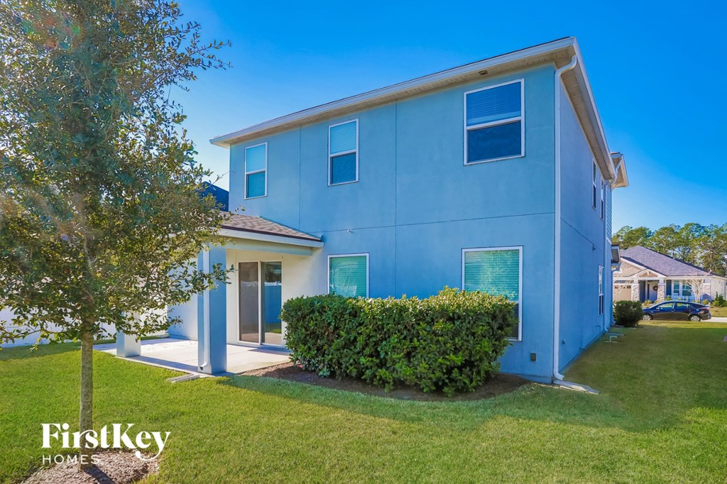 a blue house with a tree in front of it