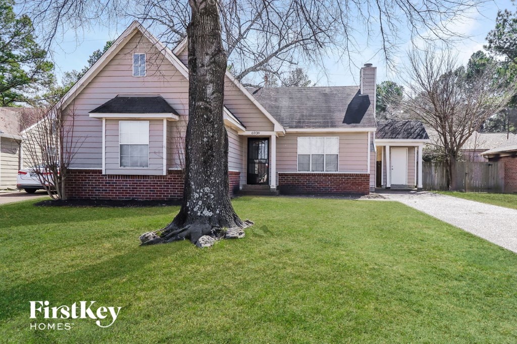 A house with a tree in front of it.