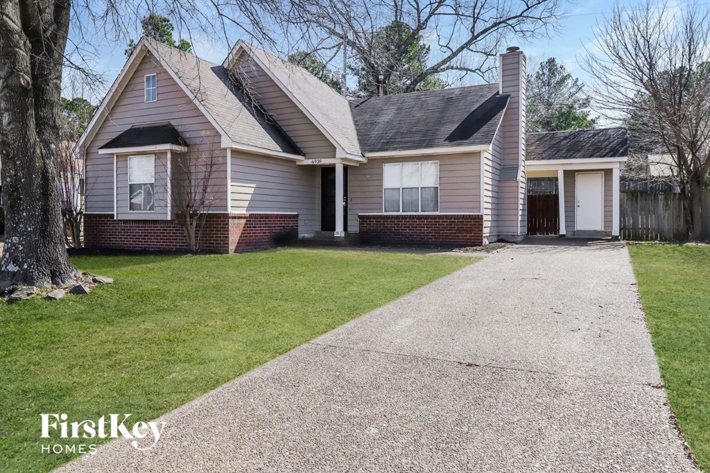 A house with a driveway in front of it.