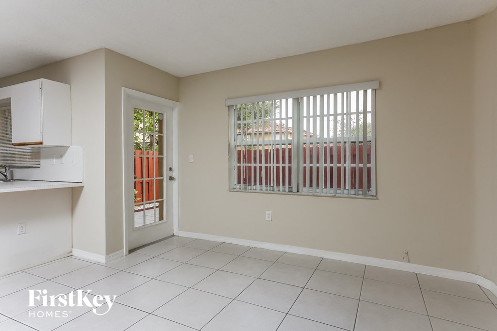 another view of the kitchen and living room with the door to the patio