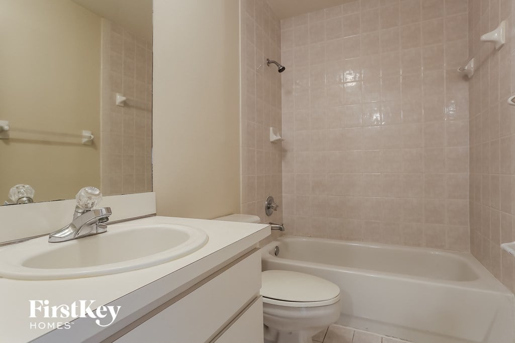 a bathroom with a sink toilet and a tub