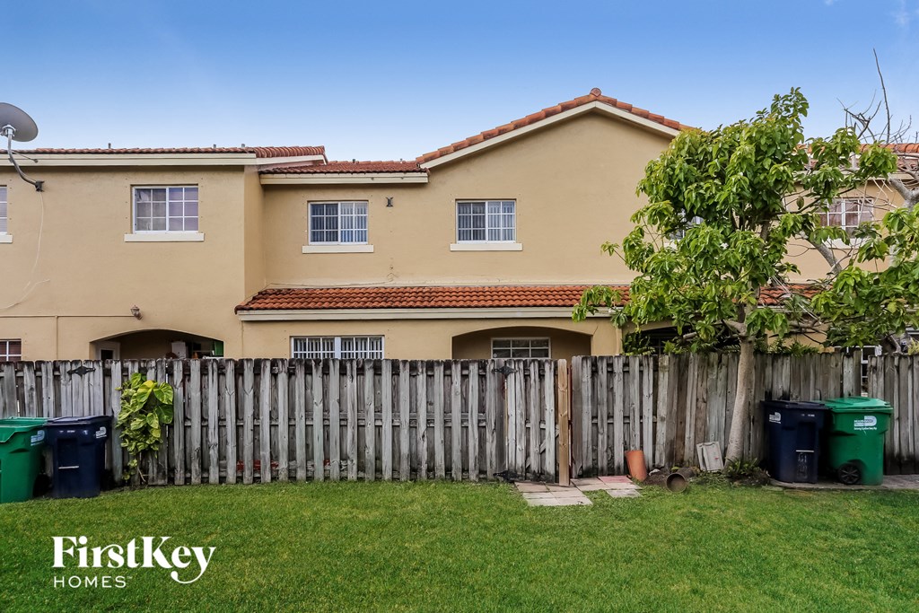 a house with a yard and a fence