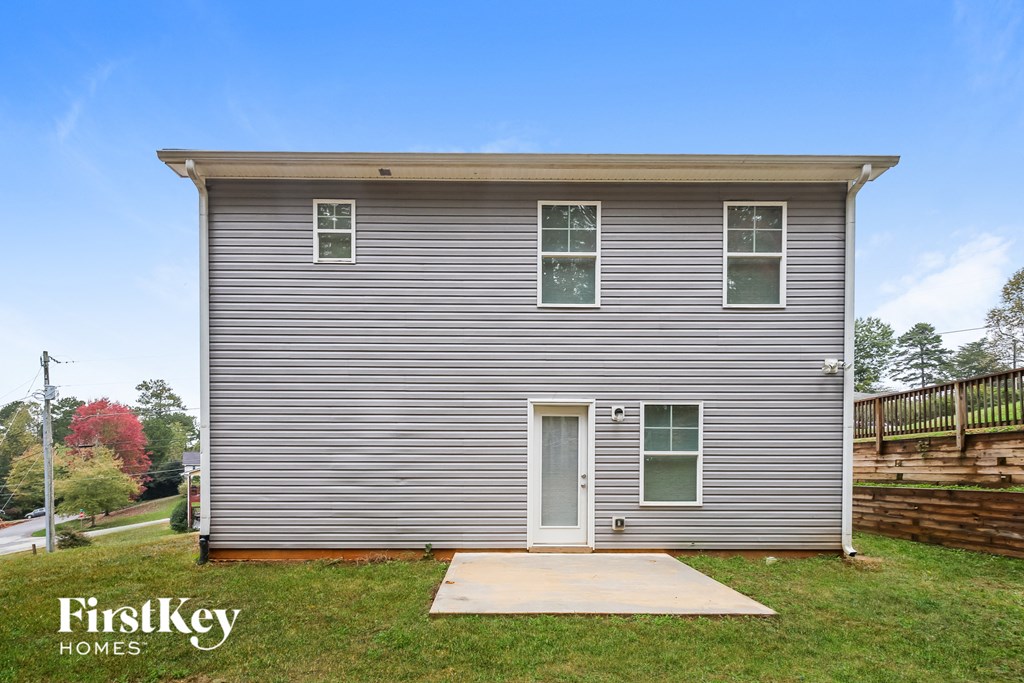 the front of a house with a ramp to the front yard